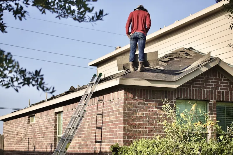 Professional roofer working on a residential roof in Hamilton Court